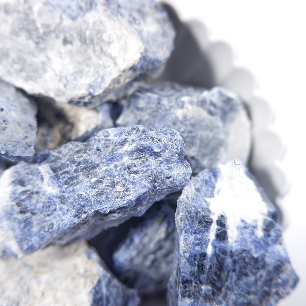 Close-up of raw sodalite chunks with black schiller and white for mindful living