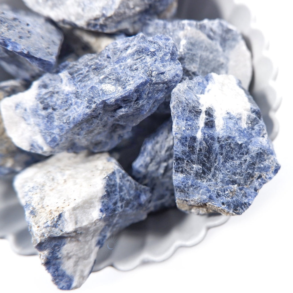 Close-up of raw sodalite chunks with black schiller and white by Tsukiyo