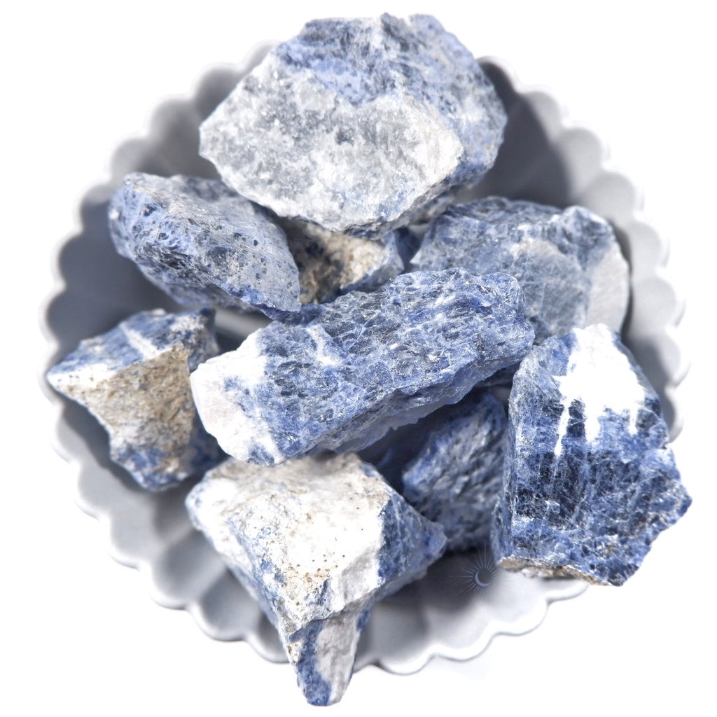 Bowl of raw sodalite chunks with black schiller and white for mindful living