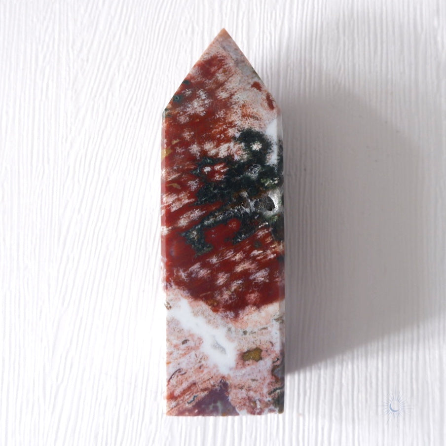 back view of Scenic pink, maroon and green ocean jasper obelisk with druzy