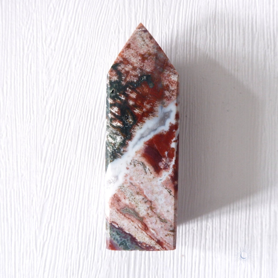 Front view of Scenic pink, maroon and green ocean jasper obelisk with druzy