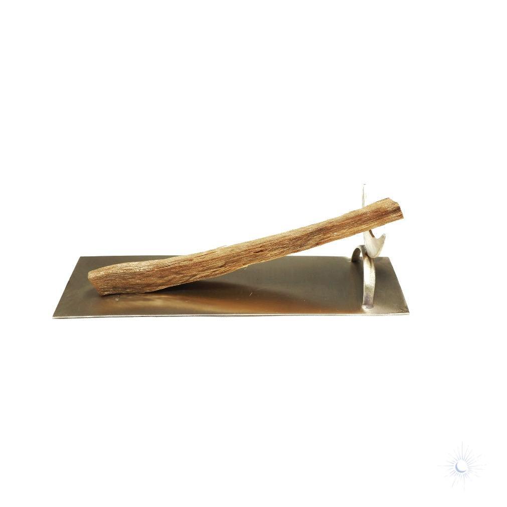 Palo santo smudge stick on brass crescent holder for mindful living