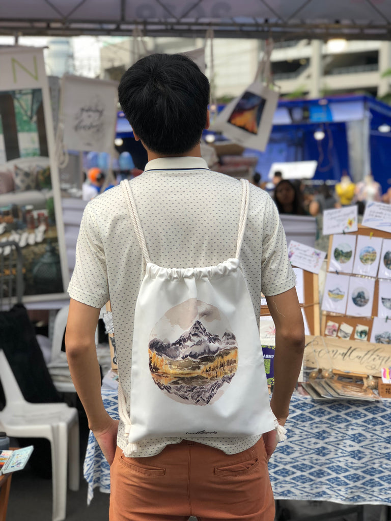 Landscape drawstring bag featuring Pyramid Lake USA by CoconutCalligraphy as seen on model