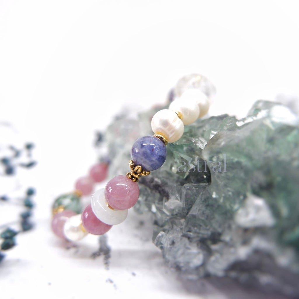 Close up view of lure me in bracelet by Astral by Tsukiyo, featuring iolite with sunstone bead